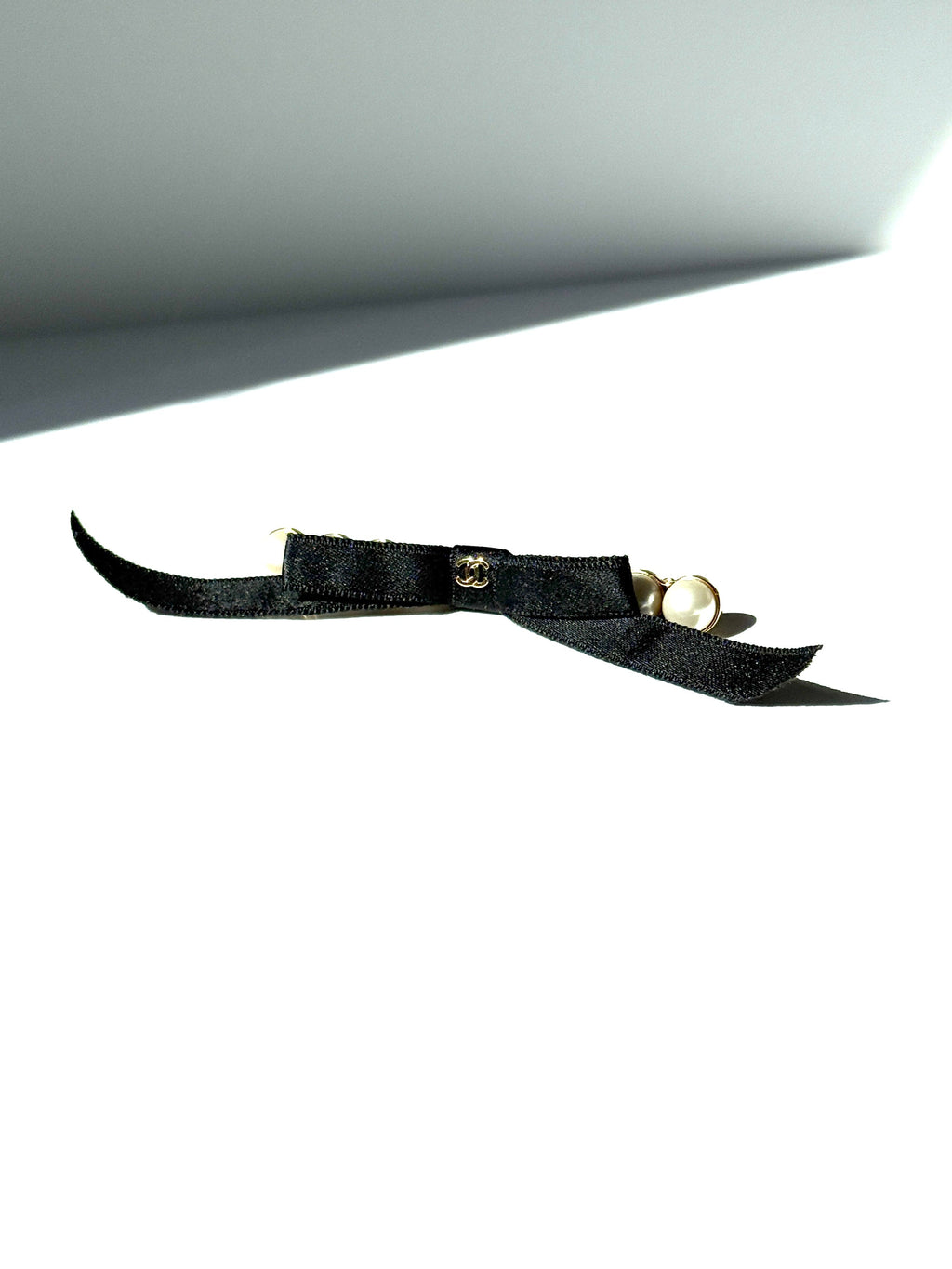 CHANEL Black Faux Pearl Bow CC Logo 2025 Gold hardware Hair Barrette Clip