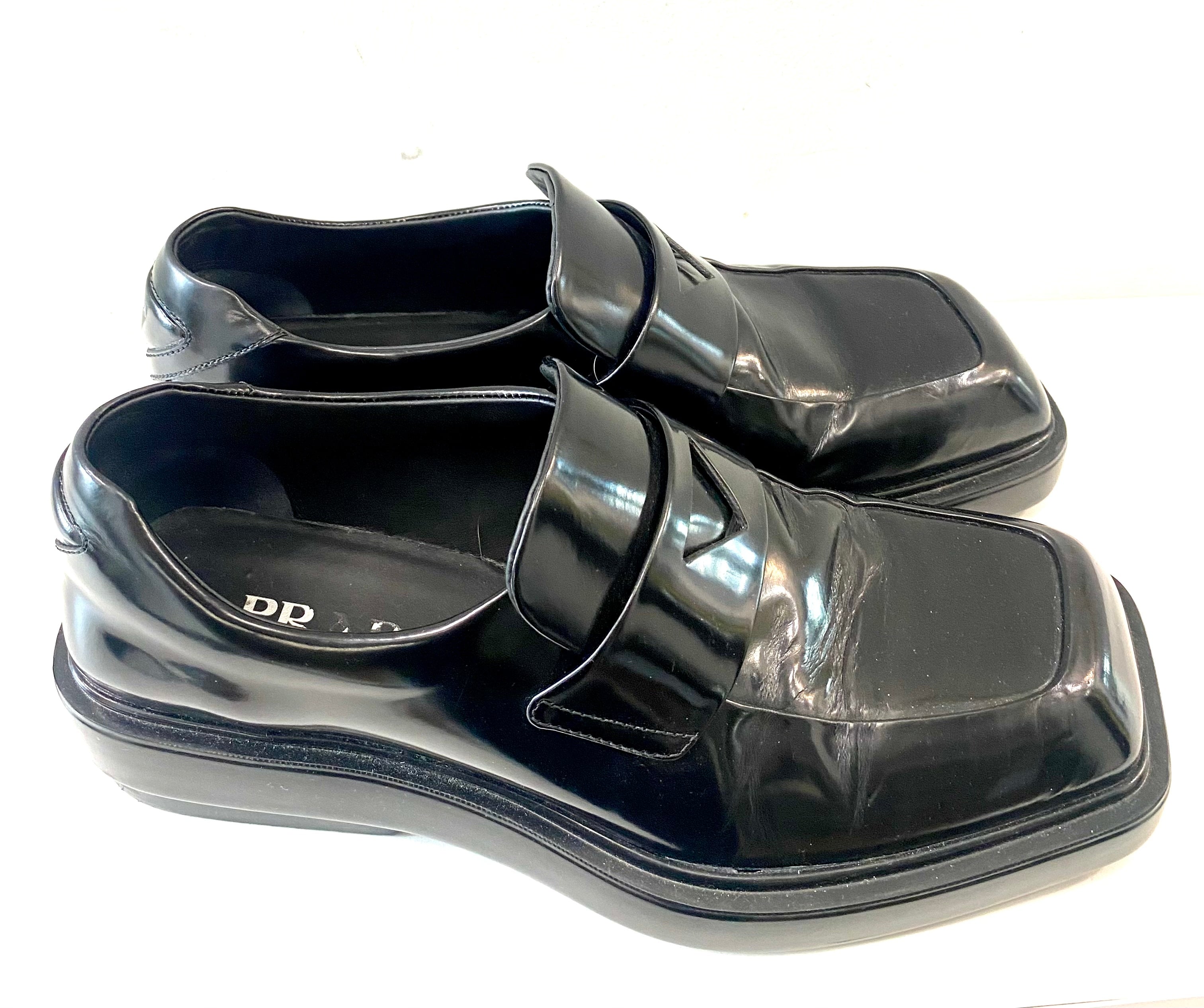 PRADA TRIANGLE LOGO PATCH SLIP-ON LOAFERS