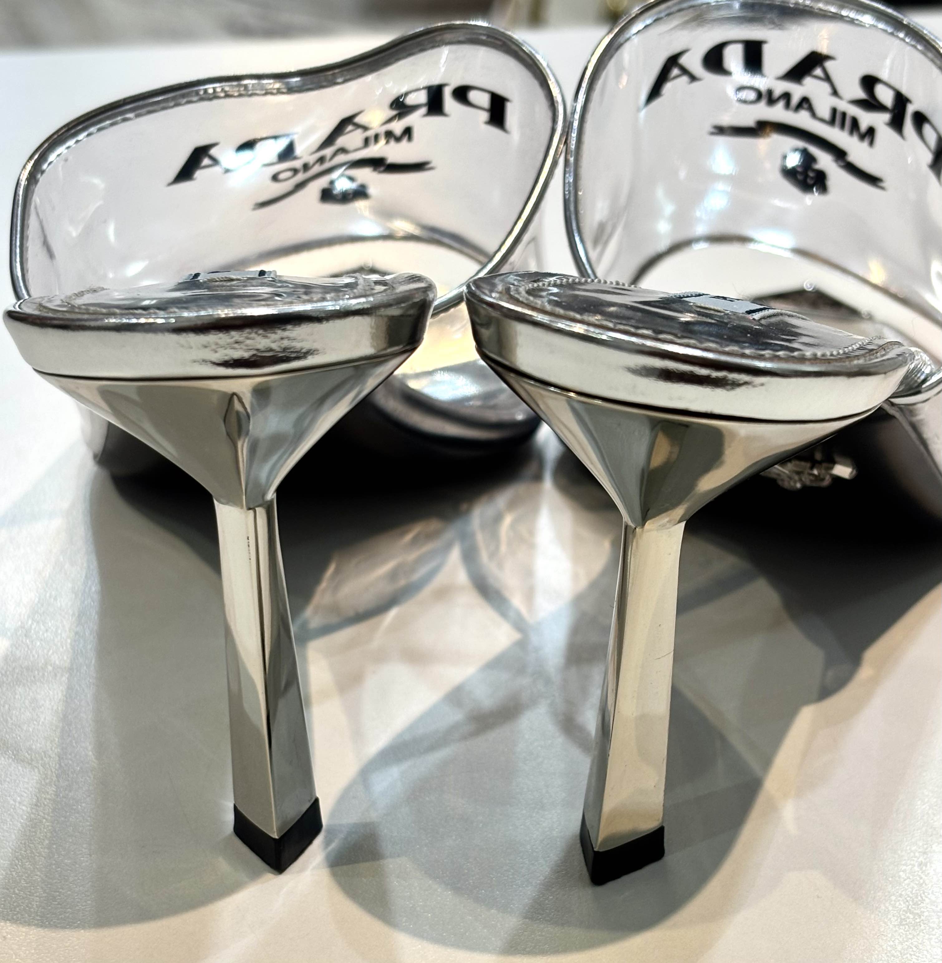 PRADA LOGO PRINT PLEXIGLASS HIGH HEEL SLIDE MULES