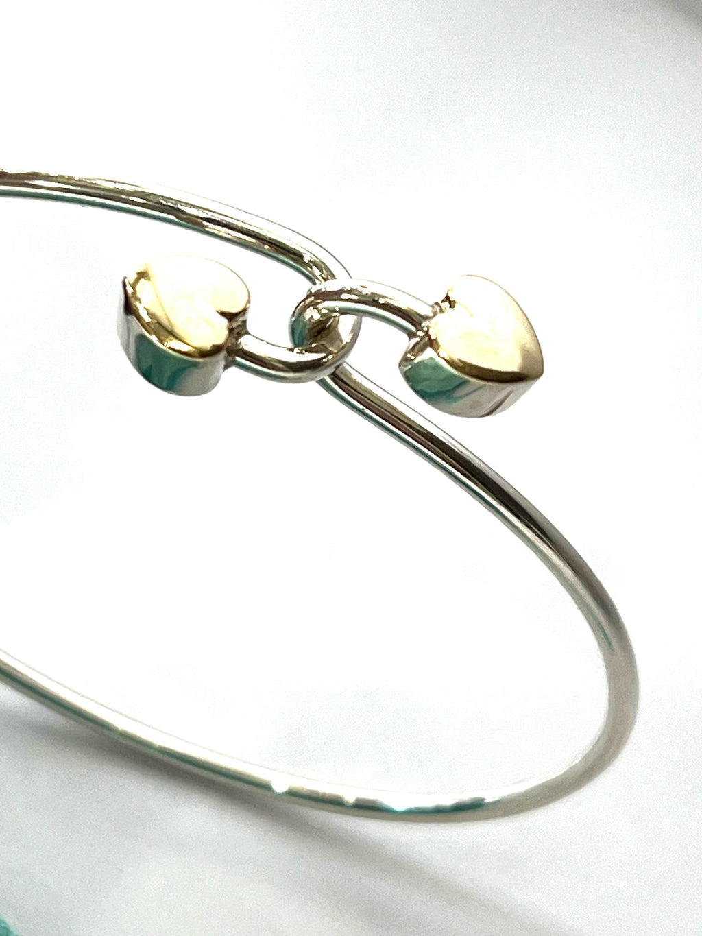 TIFFANY & CO. 18K GOLD AND STERLING SILVER HEART BANGLE BRACELET