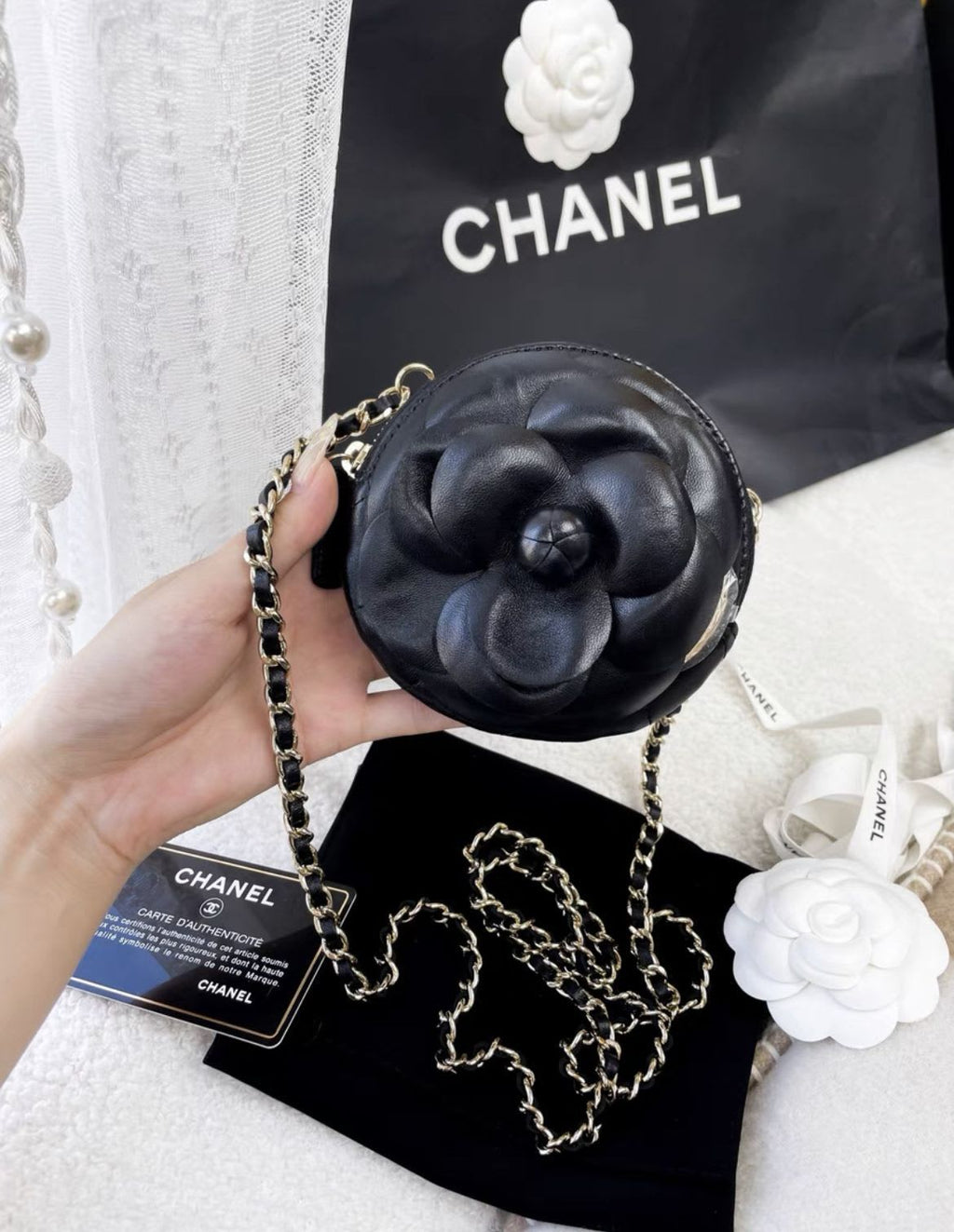 Chanel black camellia round chain bag
